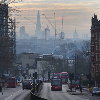 The London skyline and traffic  in winter mist from Archway Road looking towards the city