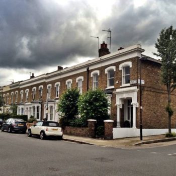 "London, UK - 4 July 2012: A row of Edwardian terraced houses typical to the Islington area of North London, UK, with ominous clouds not unfamiliar to the British summer."